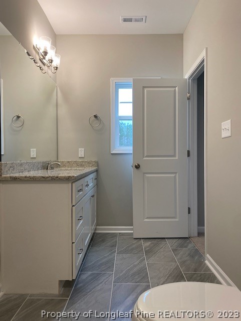 411 B & B Loop Road Raeford, NC 28376 - Photo 19 of 47 a bathroom with a sink a vanity and mirror
