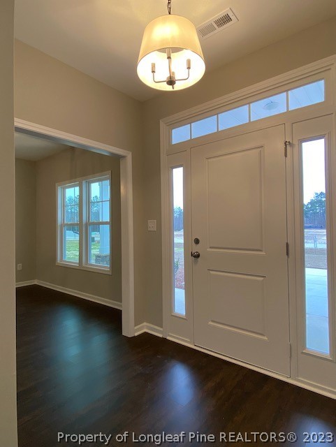 411 B & B Loop Road Raeford, NC 28376 - Photo 4 of 47 an empty room with wooden floor and windows