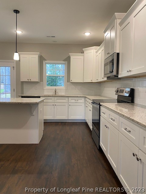 411 B & B Loop Road Raeford, NC 28376 - Photo 9 of 47 a kitchen with stainless steel appliances granite countertop a sink a stove and cabinets