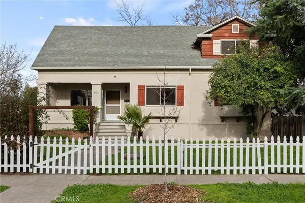 a front view of a house with wooden fence