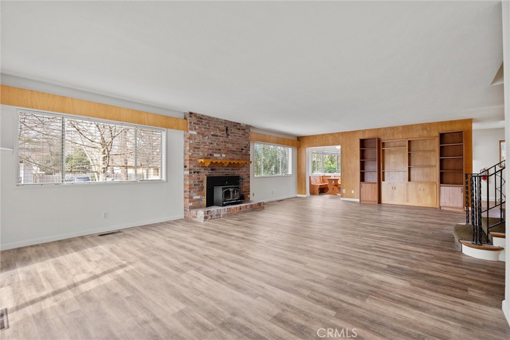 403 Ash Street Chico, CA 95928 - Photo 13 of 52 a view of empty room with wooden floor and fireplace