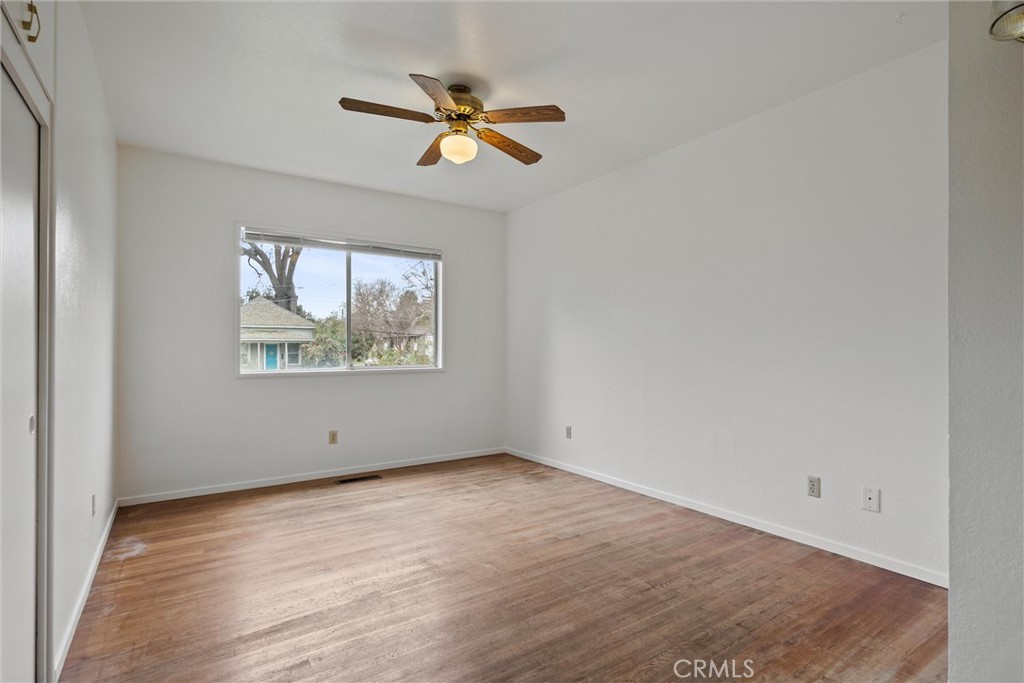 403 Ash Street Chico, CA 95928 - Photo 30 of 52 an empty room with wooden floor fan and windows