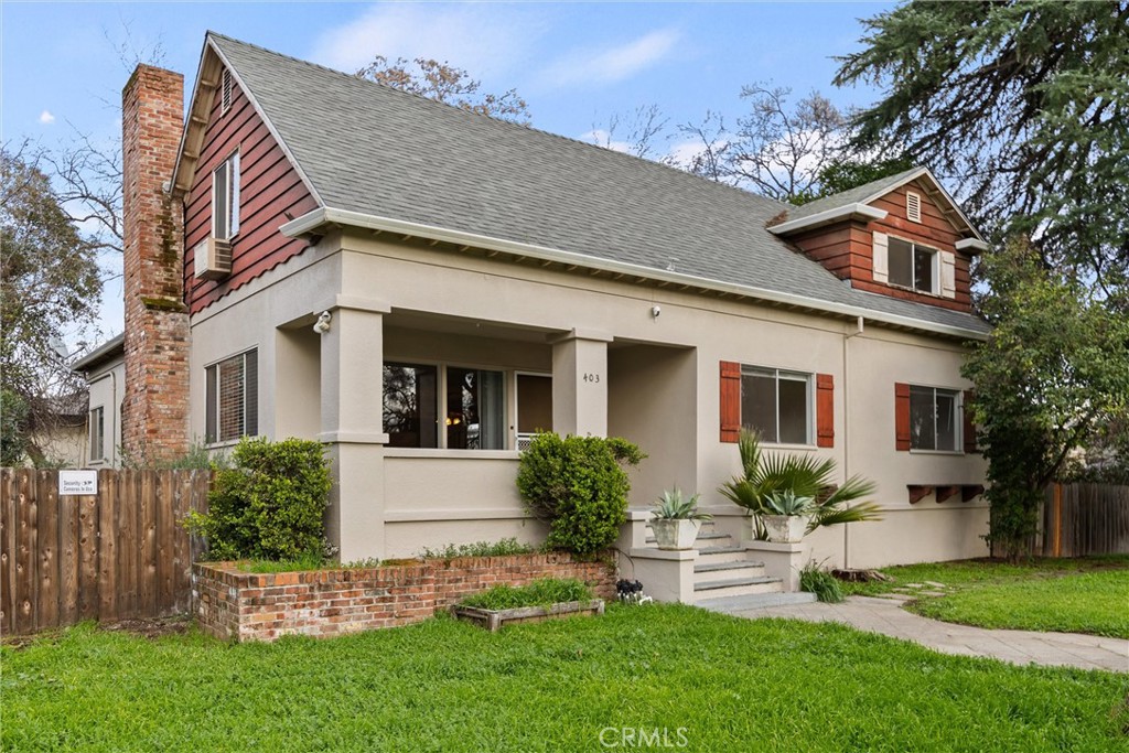 403 Ash Street Chico, CA 95928 - Photo 5 of 52 a front view of a house with a garden and plants