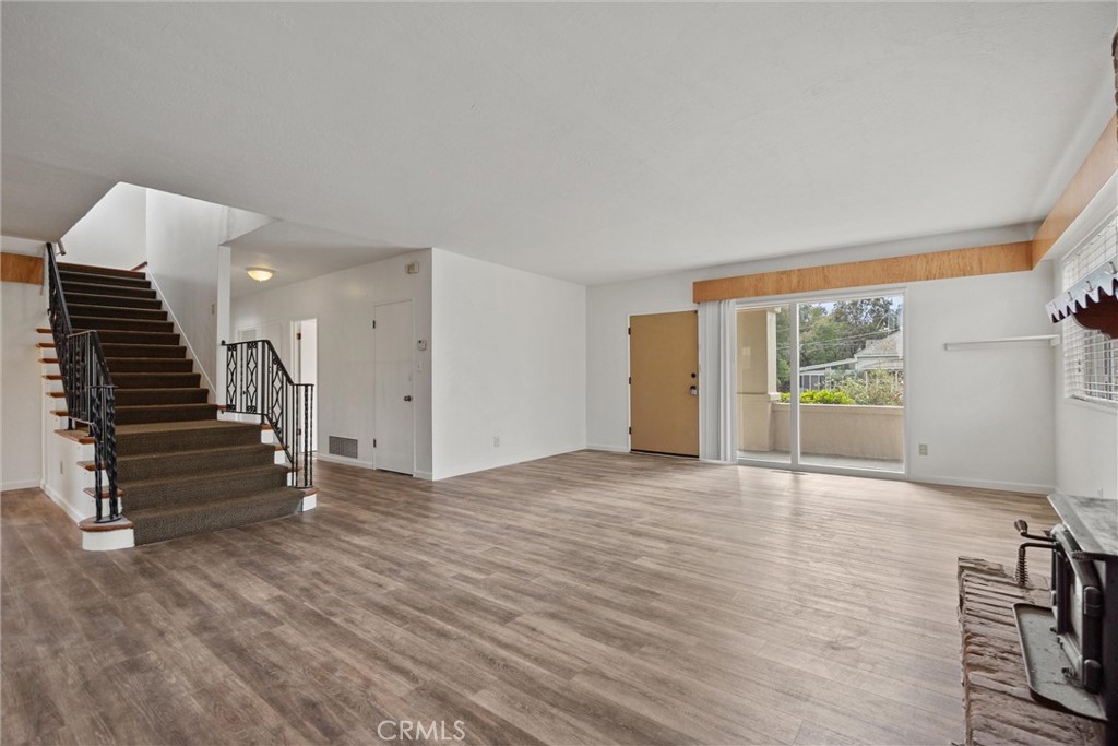 403 Ash Street Chico, CA 95928 - Photo 9 of 52 a view of an empty room with wooden floor and stairs
