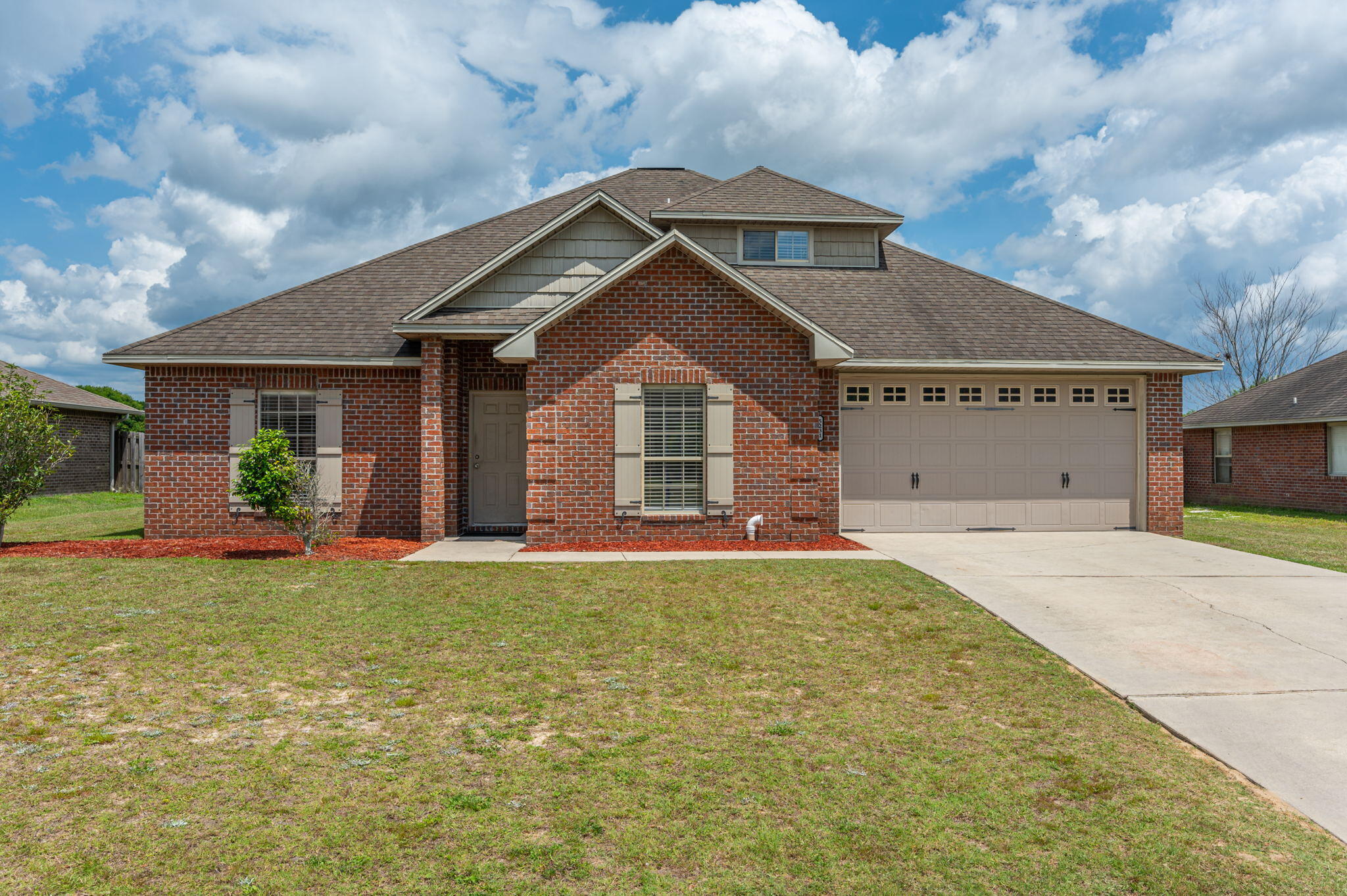 5231 Moore Loop Crestview, FL 32536 - Photo 1 of 45 a front view of a house with a yard and garage