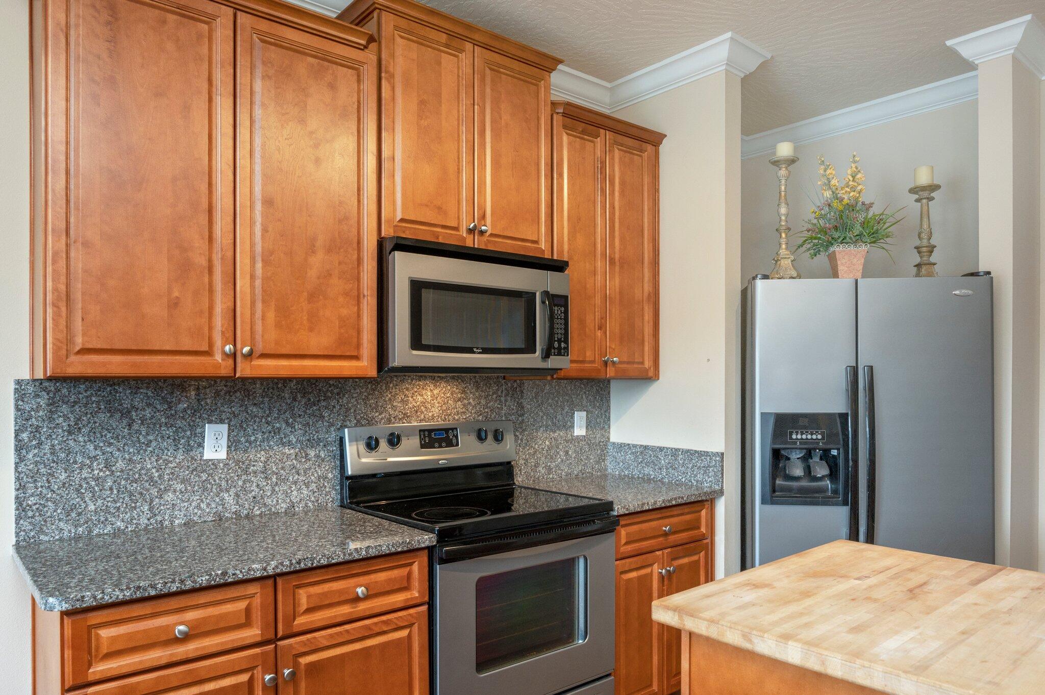 5231 Moore Loop Crestview, FL 32536 - Photo 11 of 45 a kitchen with stainless steel appliances granite countertop a refrigerator microwave and sink