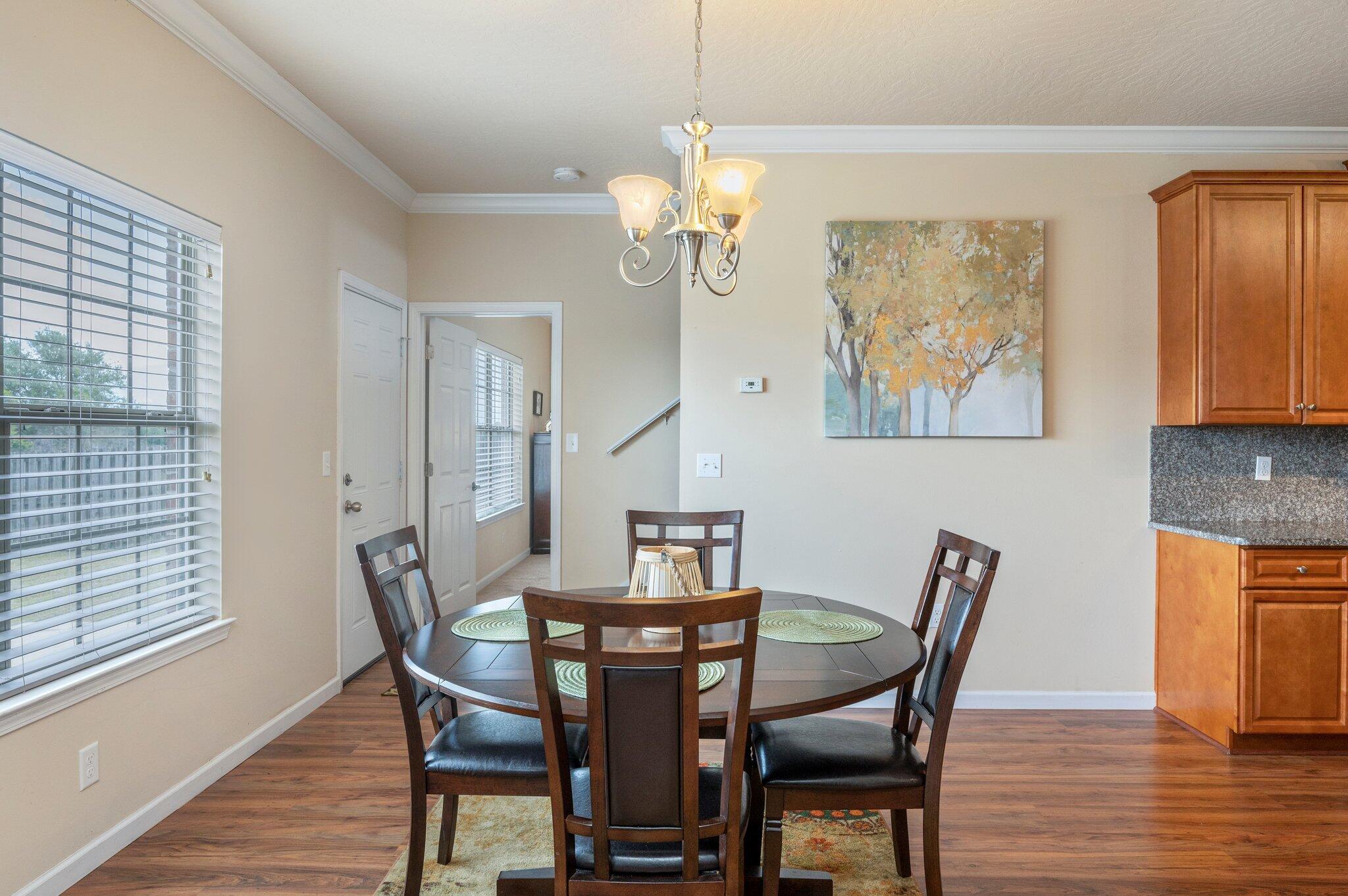 5231 Moore Loop Crestview, FL 32536 - Photo 13 of 45 a view of a dining room with furniture a chandelier and wooden floor