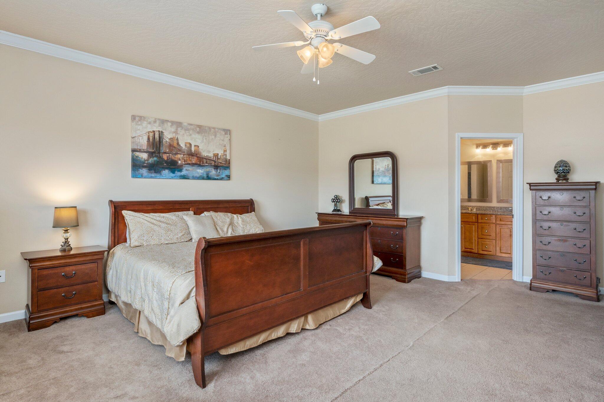 5231 Moore Loop Crestview, FL 32536 - Photo 14 of 45 a bed room with a bed and a chandelier