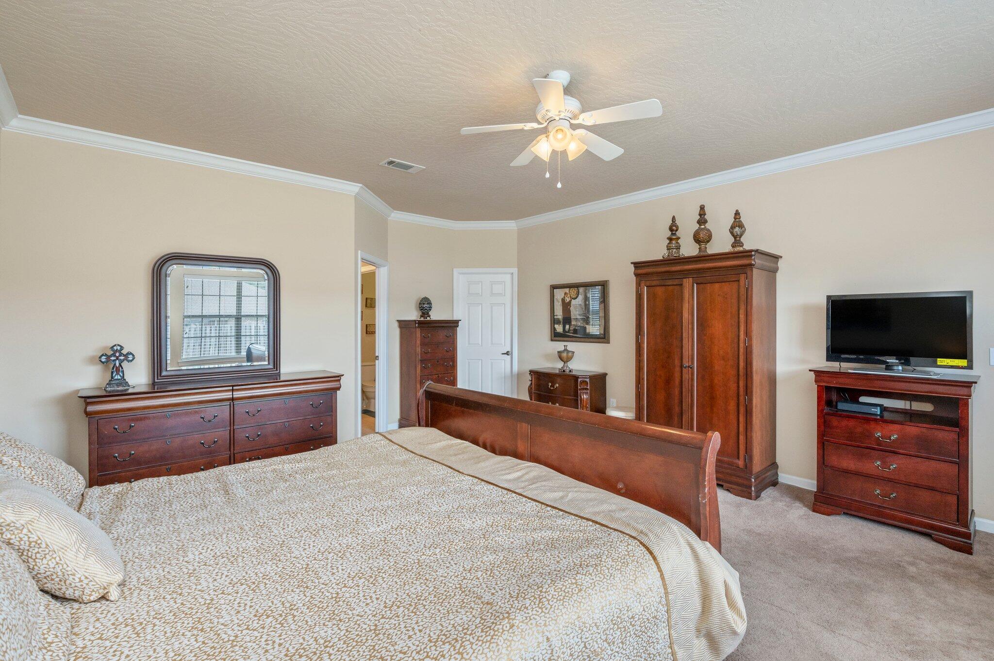 5231 Moore Loop Crestview, FL 32536 - Photo 15 of 45 a bedroom with a bed and a flat screen tv