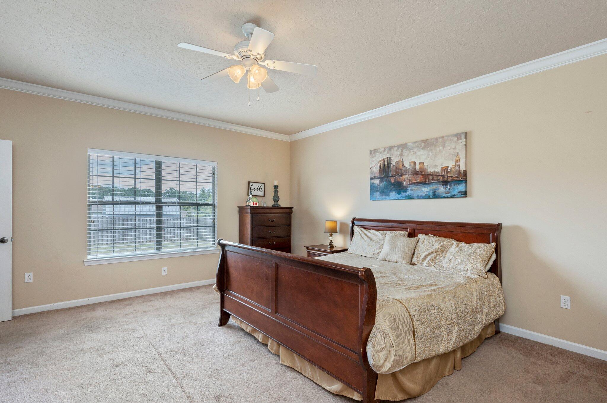 5231 Moore Loop Crestview, FL 32536 - Photo 16 of 45 a bed room with a bed and a tv