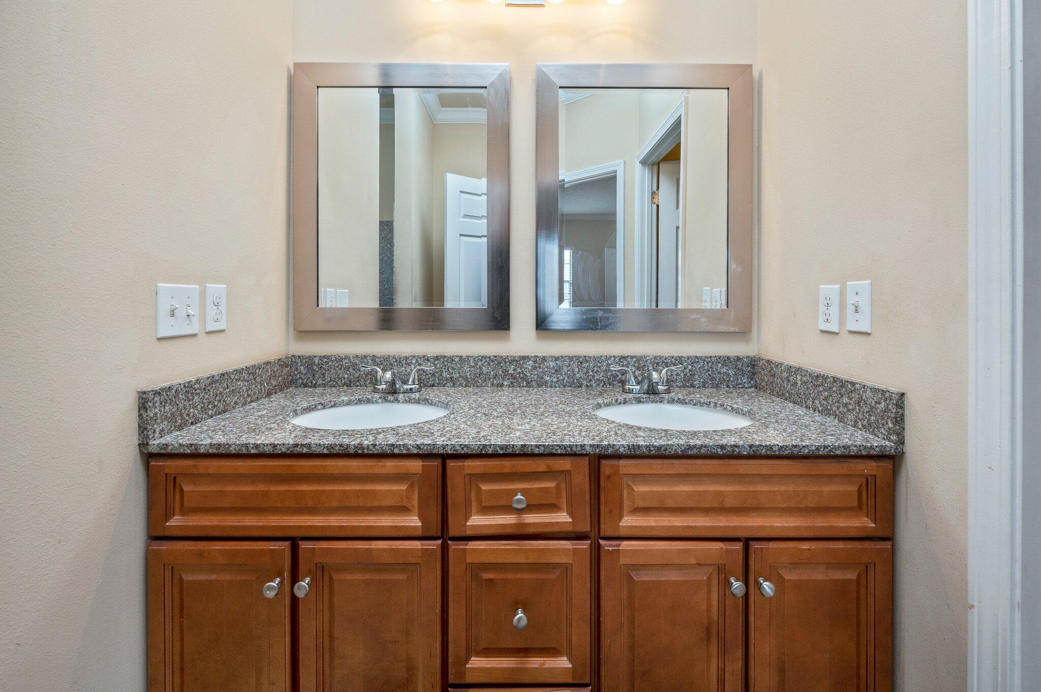 5231 Moore Loop Crestview, FL 32536 - Photo 17 of 45 a bathroom with a granite countertop sink and a mirror