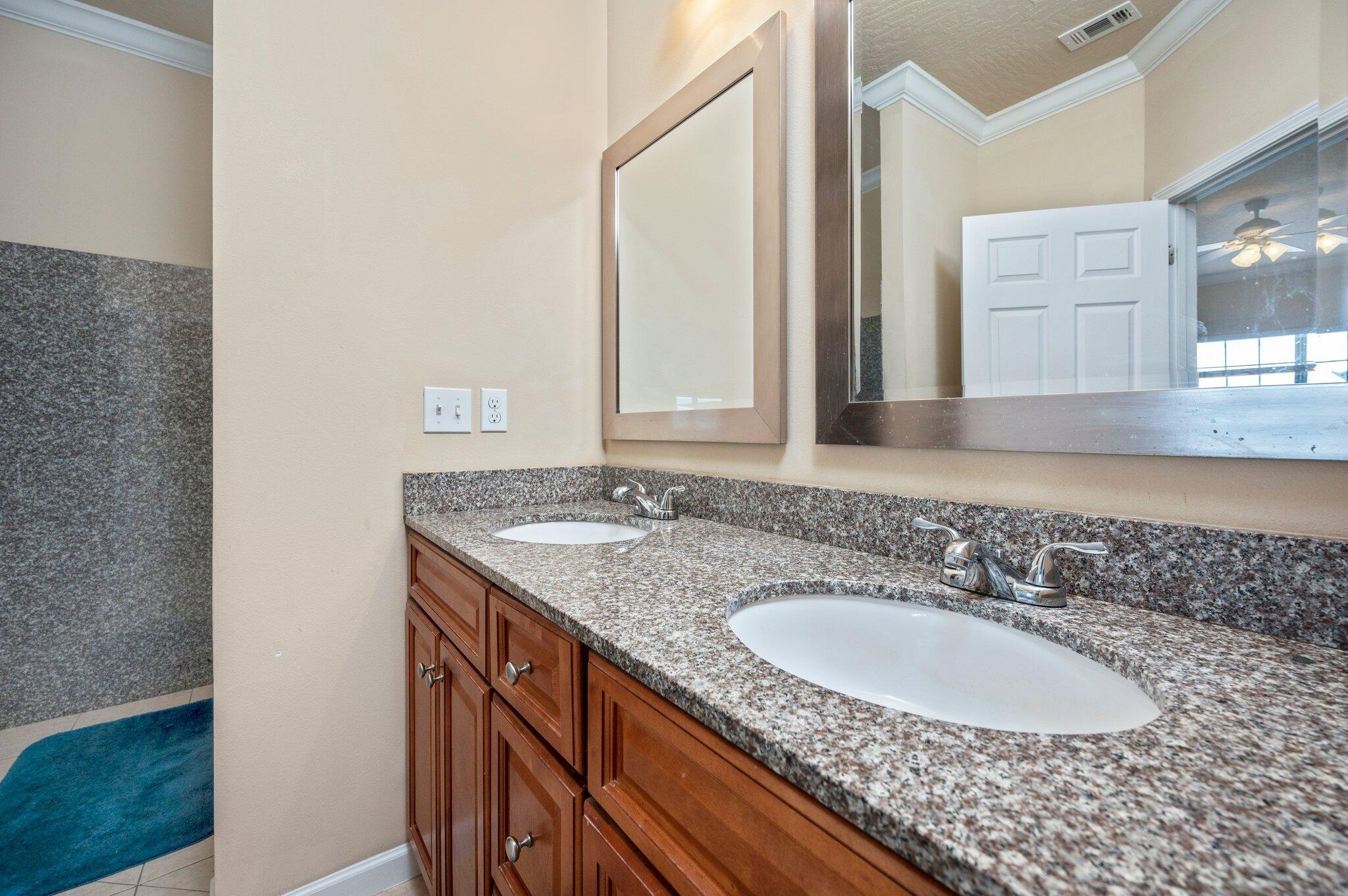 5231 Moore Loop Crestview, FL 32536 - Photo 18 of 45 a bathroom with a granite countertop sink and a mirror