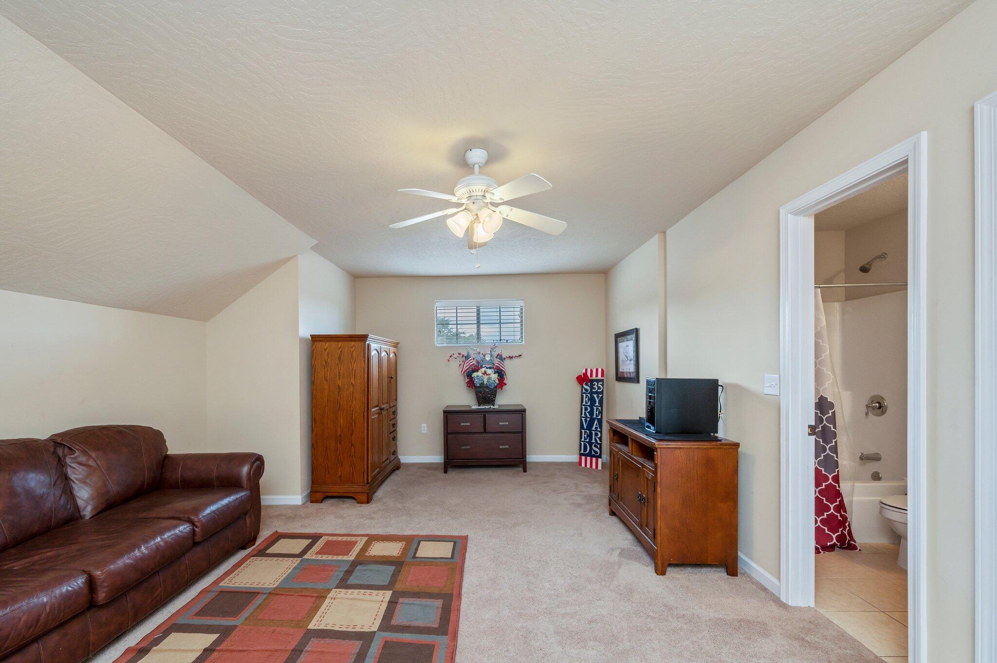 5231 Moore Loop Crestview, FL 32536 - Photo 23 of 45 a living room with furniture and a chandelier