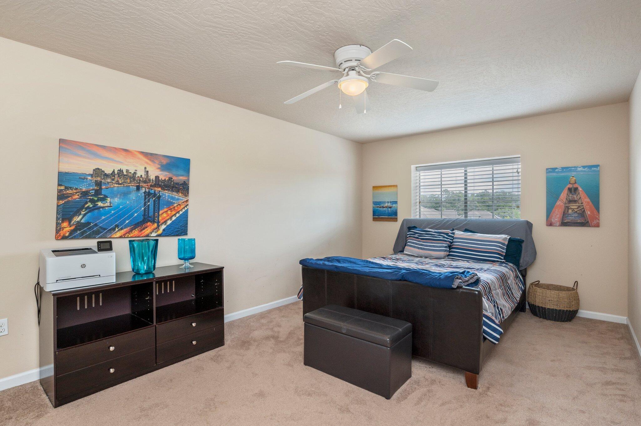 5231 Moore Loop Crestview, FL 32536 - Photo 26 of 45 a bedroom with a bed and a flat screen tv