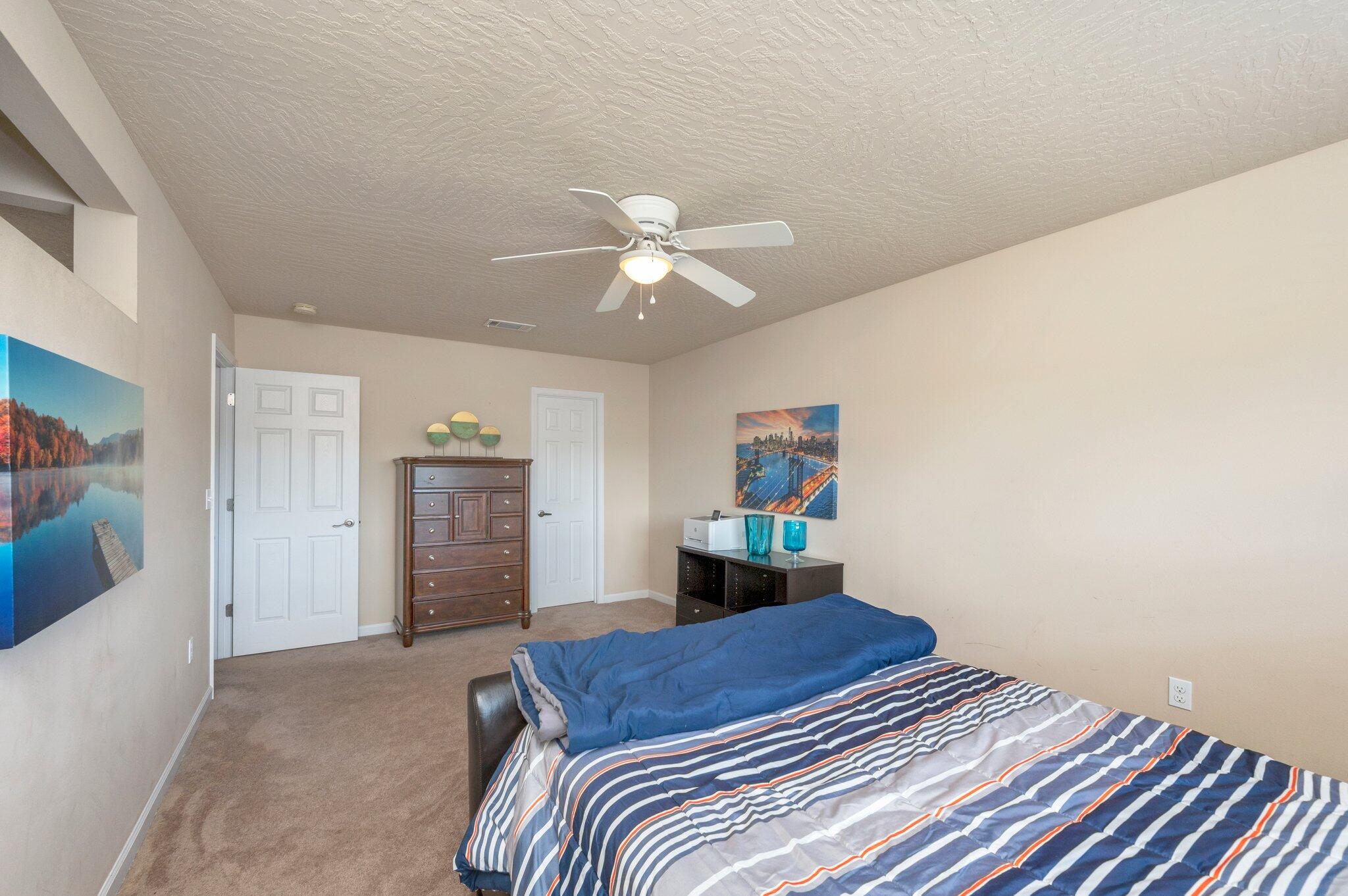 5231 Moore Loop Crestview, FL 32536 - Photo 27 of 45 a bedroom with a bed and a chandelier