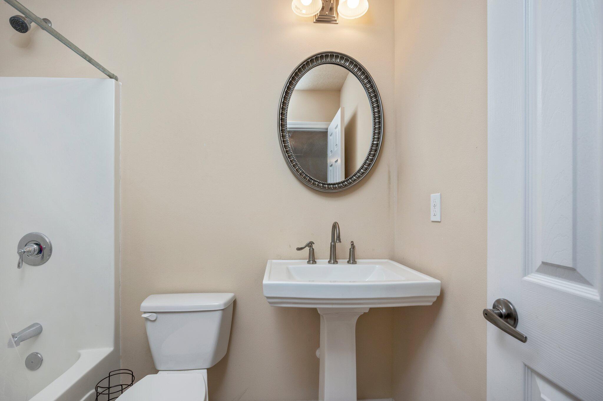5231 Moore Loop Crestview, FL 32536 - Photo 28 of 45 a bathroom with a sink and a mirror