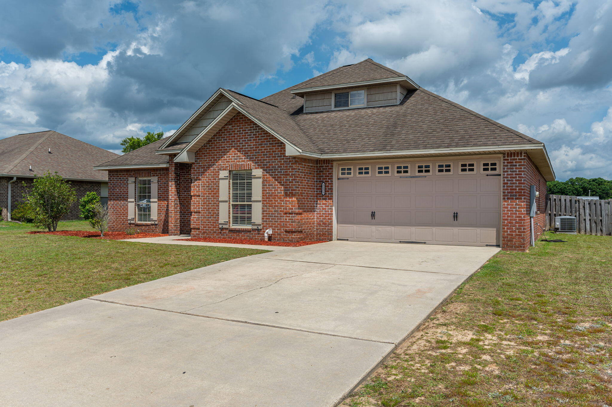 5231 Moore Loop Crestview, FL 32536 - Photo 3 of 45 a front view of a house with a yard and garage