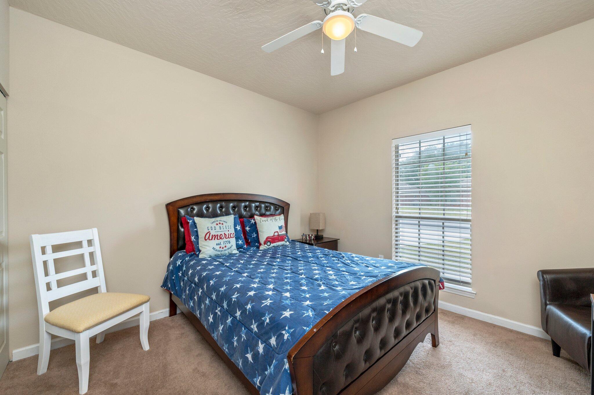5231 Moore Loop Crestview, FL 32536 - Photo 31 of 45 a bedroom with a bed and a table in it