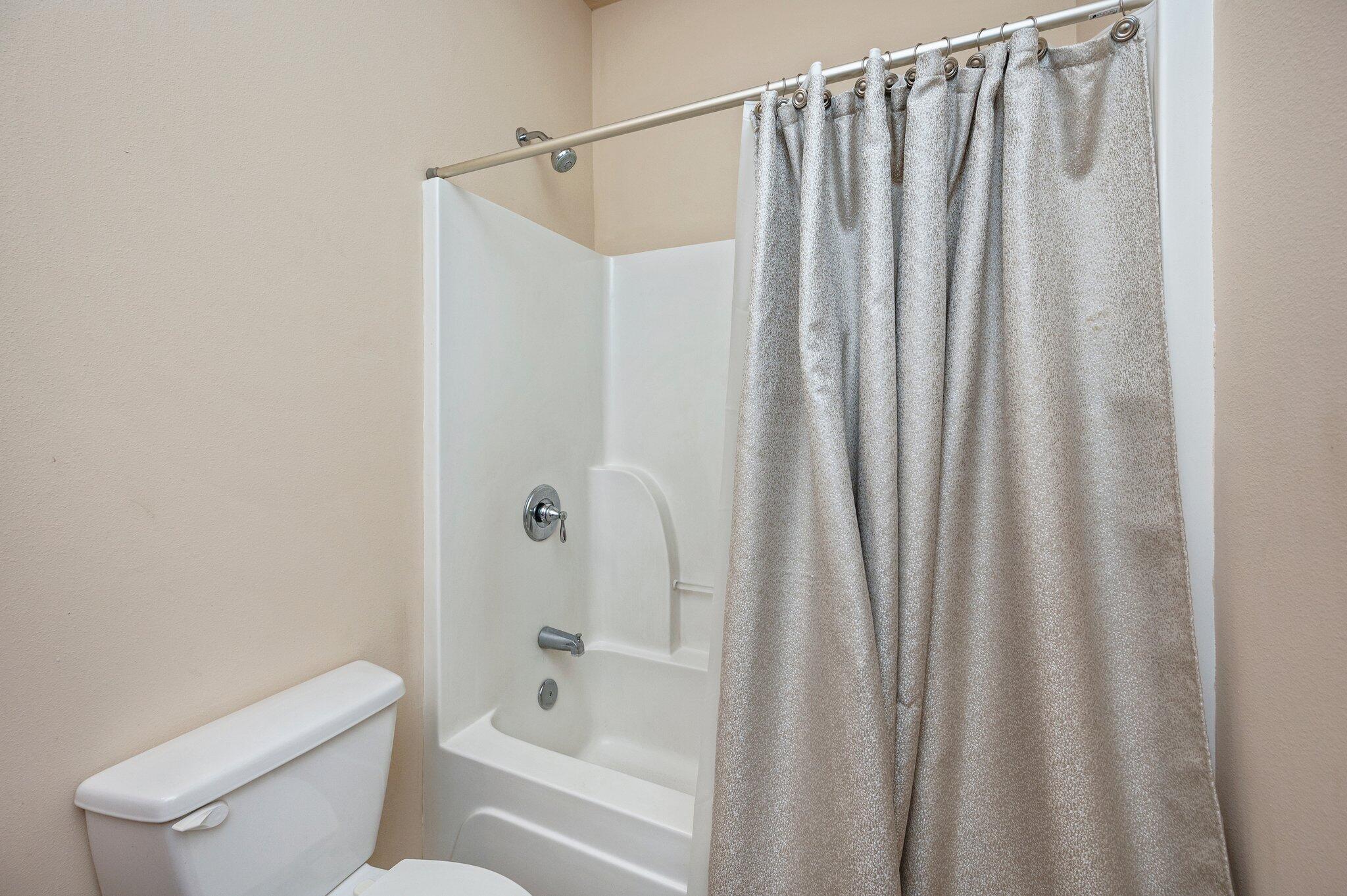 5231 Moore Loop Crestview, FL 32536 - Photo 33 of 45 a bathroom with a shower curtain and toilet