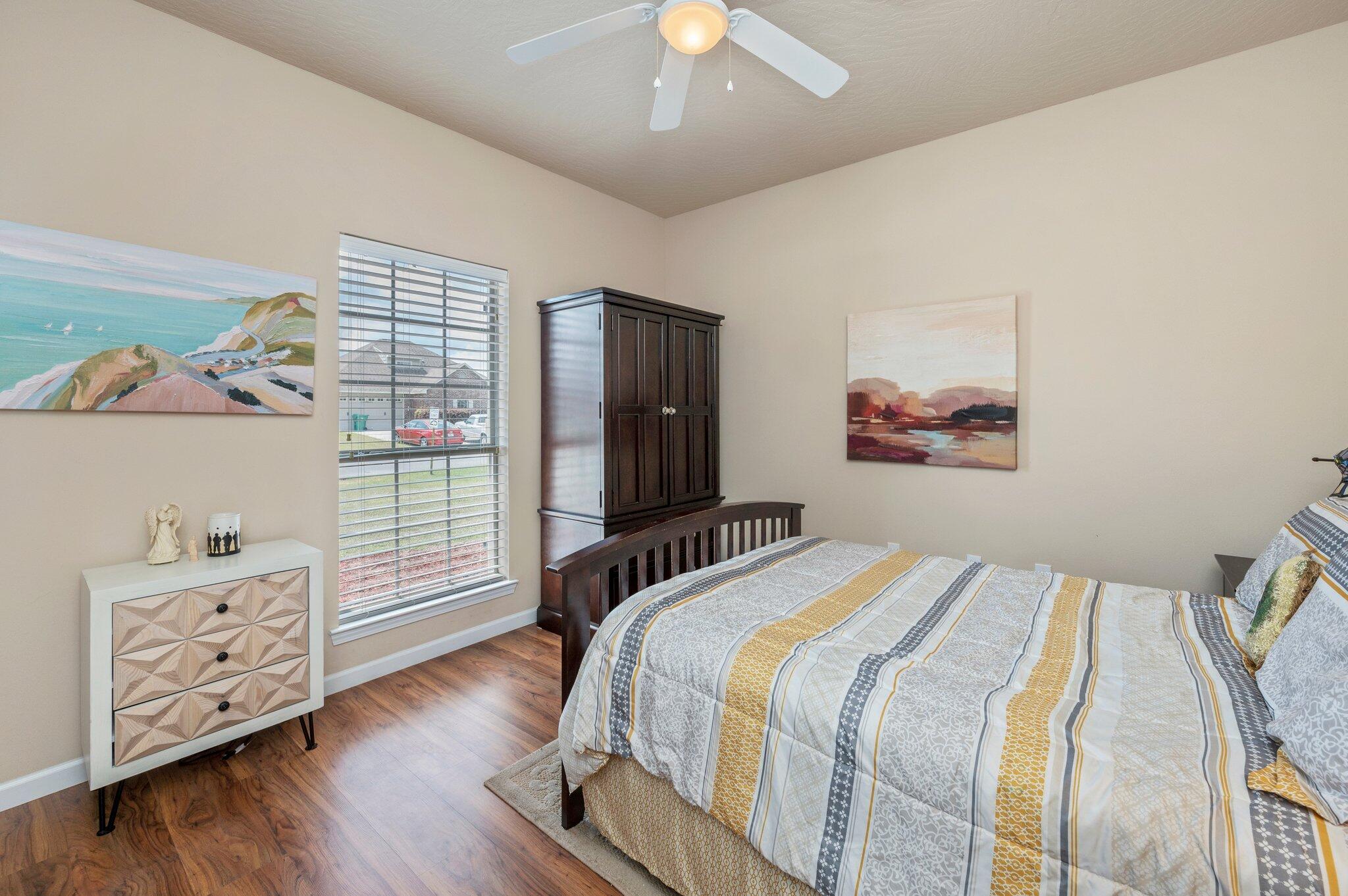 5231 Moore Loop Crestview, FL 32536 - Photo 35 of 45 a bedroom with bed and wooden floor