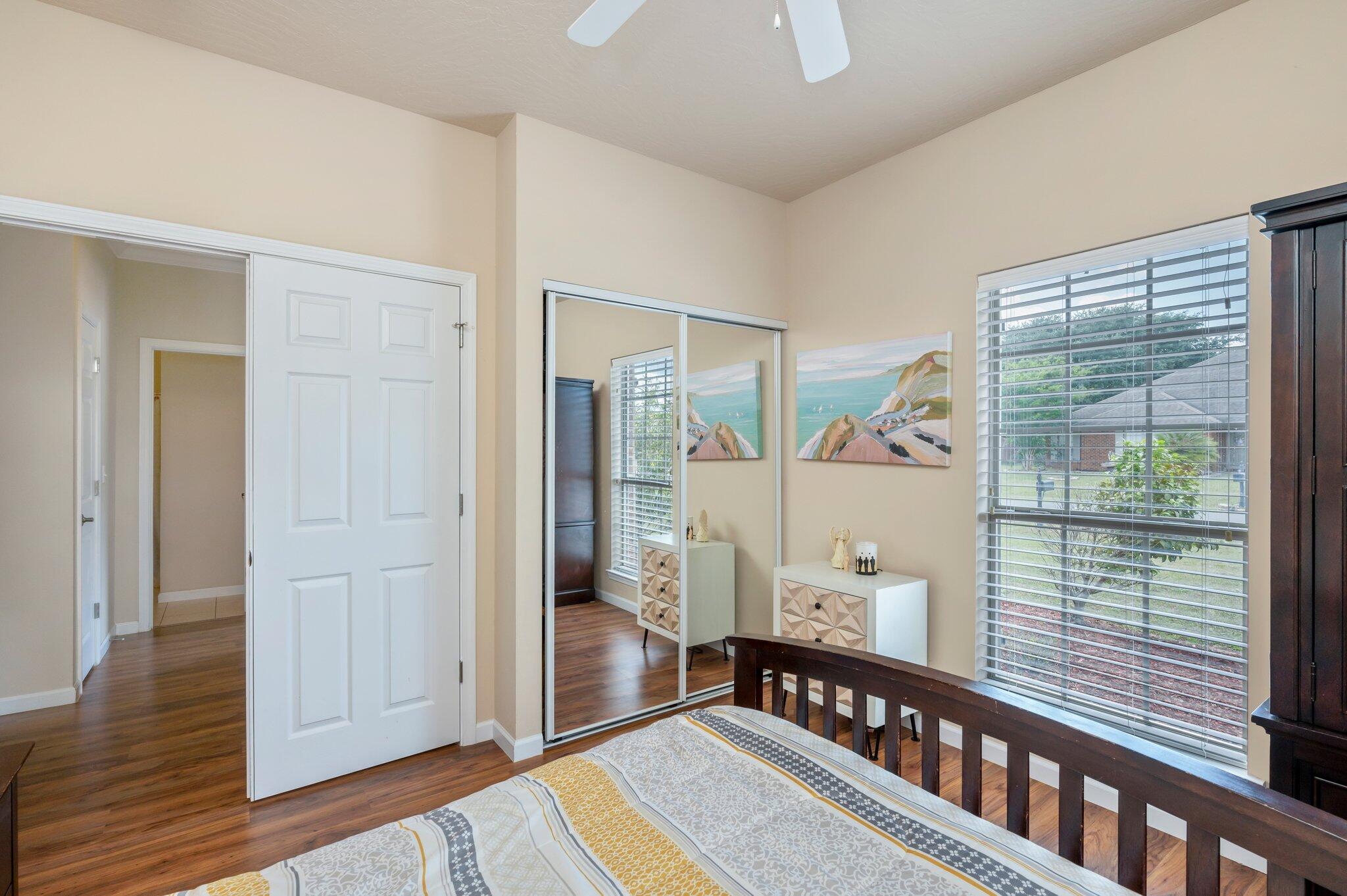 5231 Moore Loop Crestview, FL 32536 - Photo 36 of 45 a view of a hallway with wooden floor and windows