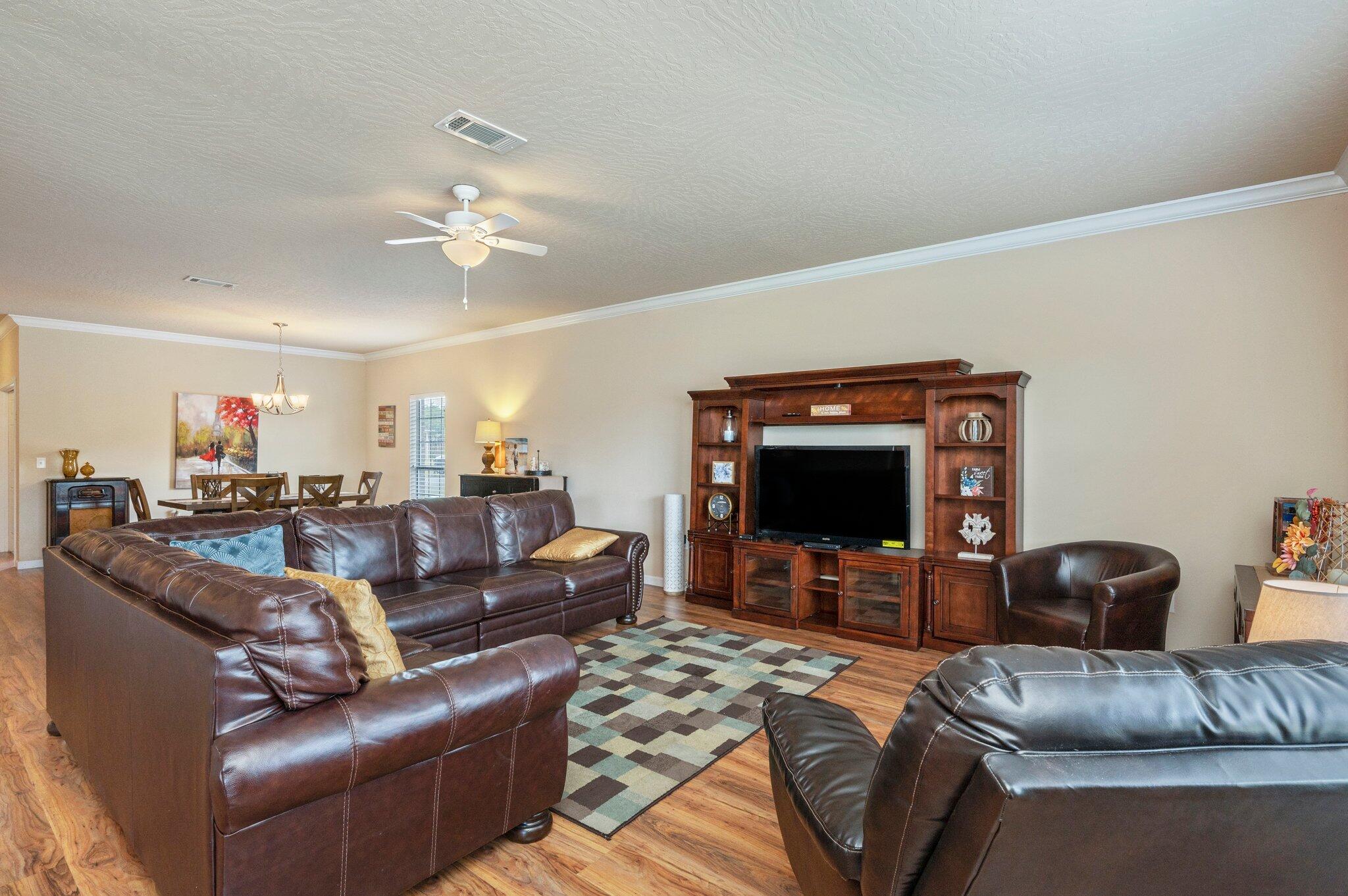 5231 Moore Loop Crestview, FL 32536 - Photo 4 of 45 a living room with furniture and a flat screen tv