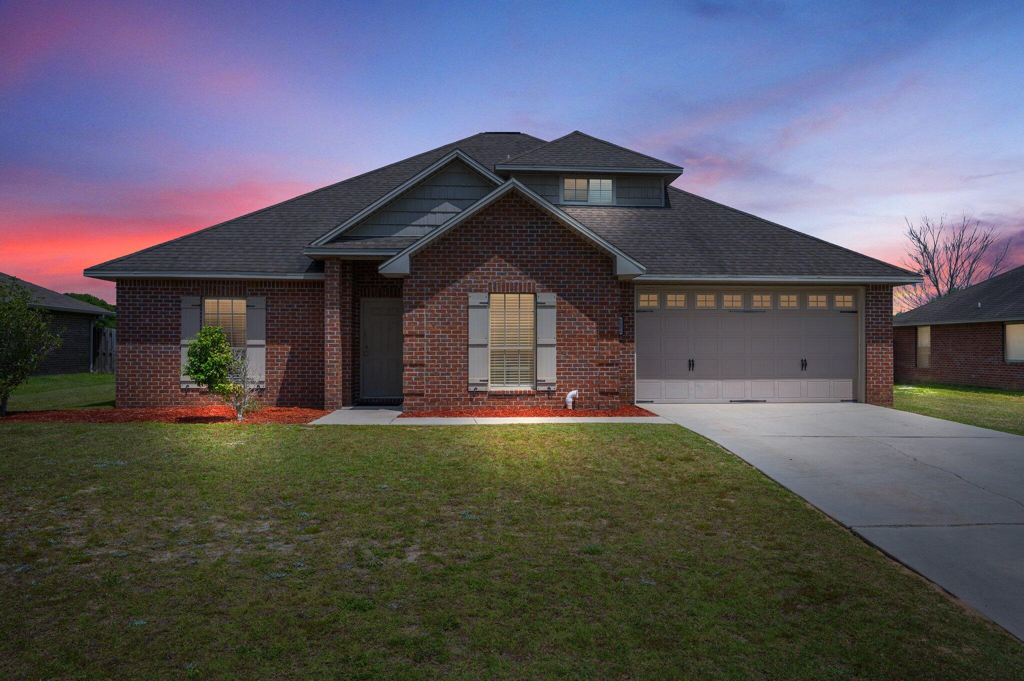 5231 Moore Loop Crestview, FL 32536 - Photo 42 of 45 a front view of a house with a yard and garage