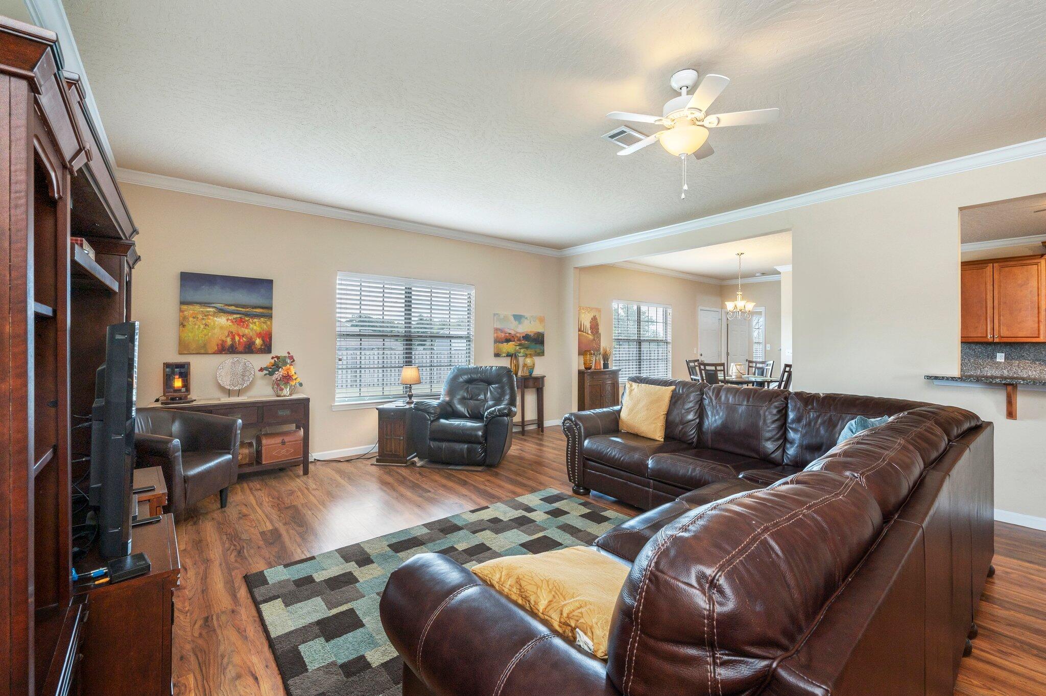 5231 Moore Loop Crestview, FL 32536 - Photo 6 of 45 a living room with furniture large window and a flat screen tv