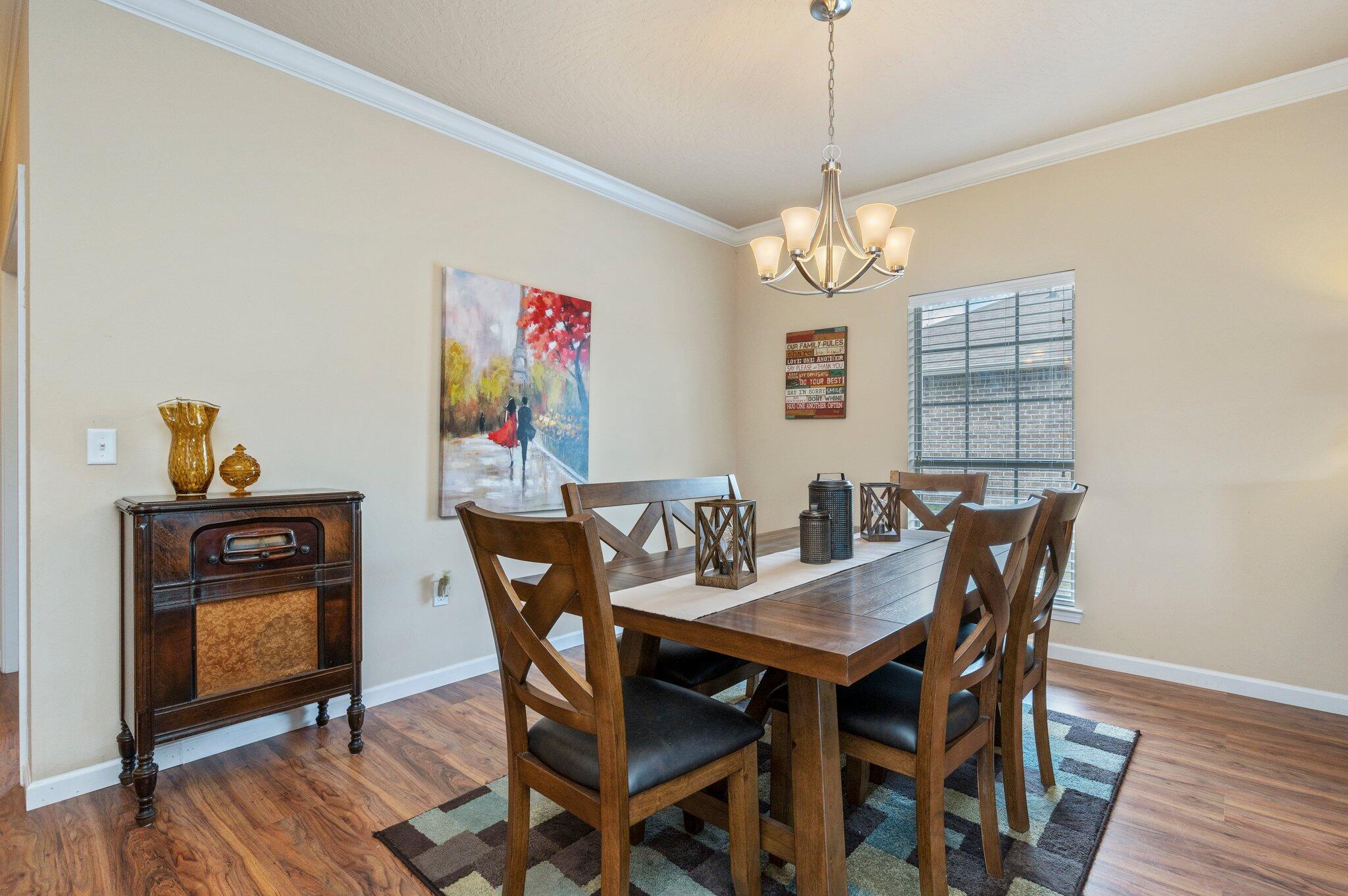 5231 Moore Loop Crestview, FL 32536 - Photo 7 of 45 a view of a dining room with furniture wooden floor and a chandelier