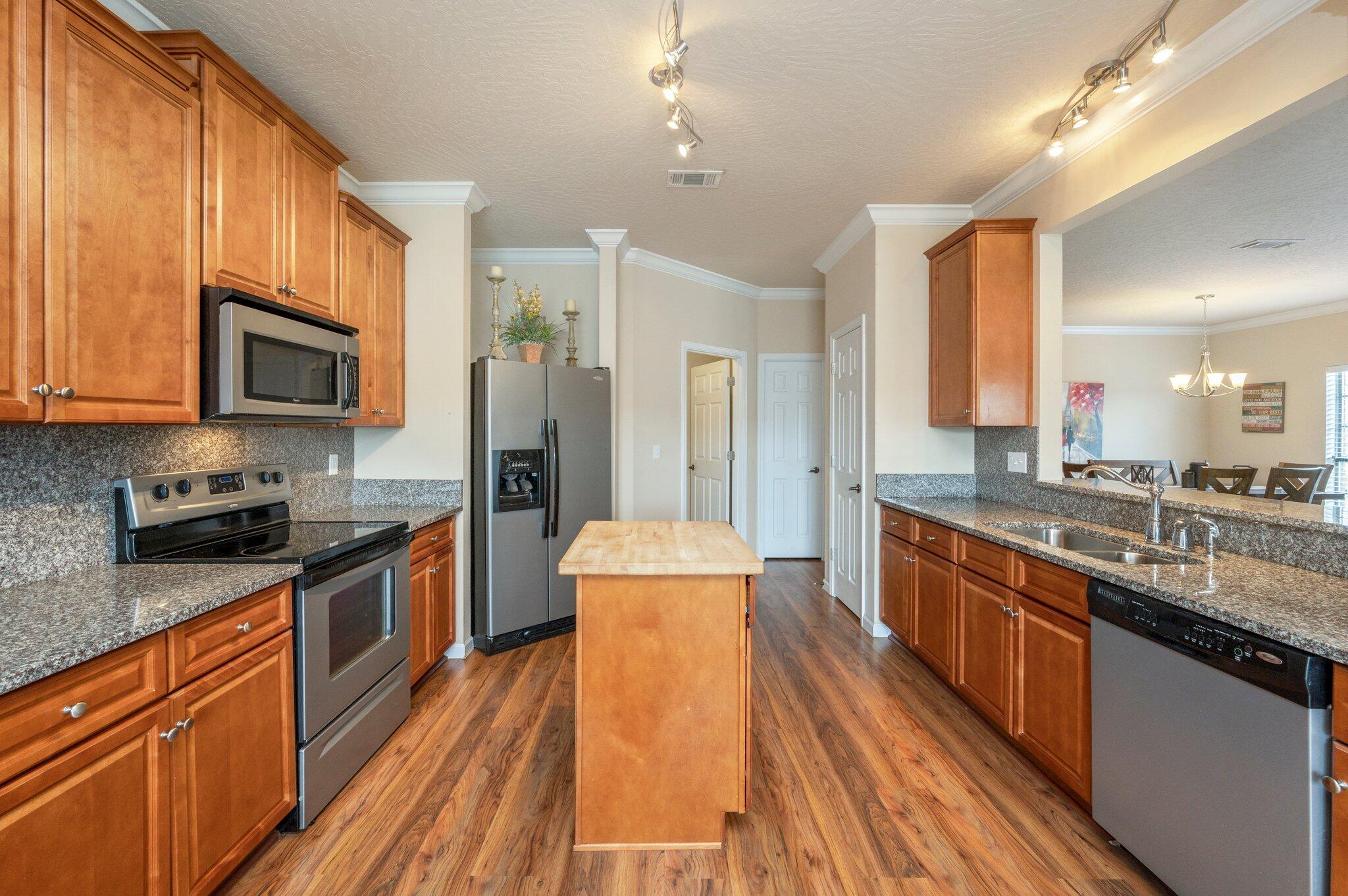 5231 Moore Loop Crestview, FL 32536 - Photo 8 of 45 a large kitchen with stainless steel appliances granite countertop lots of counter top space a sink and cabinets