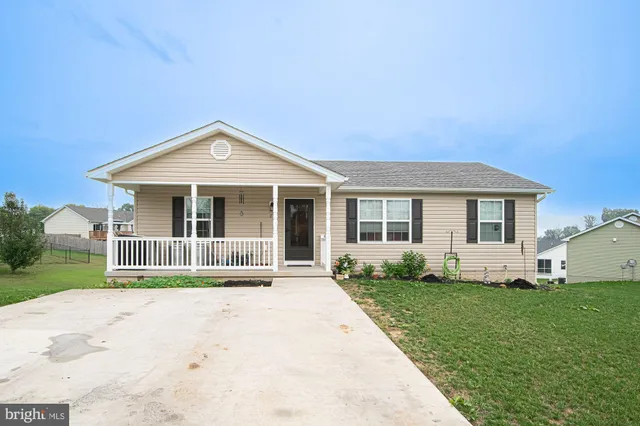 a front view of a house with a yard and porch