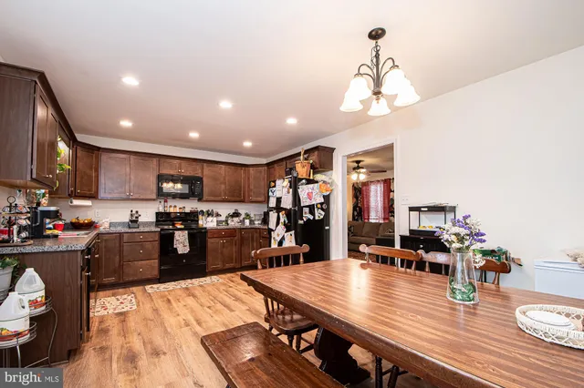 a kitchen and a dining room with wooden floor