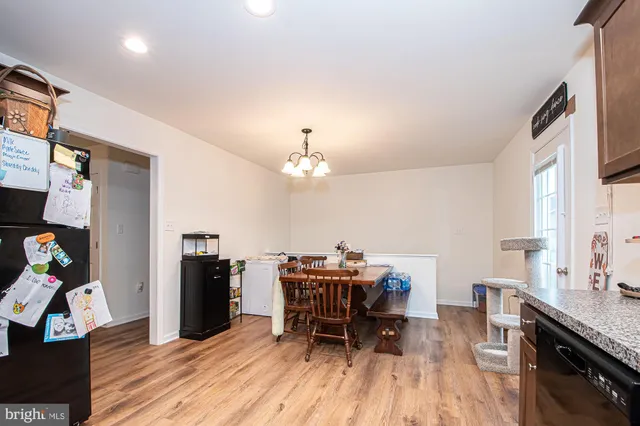 a dining room with furniture and wooden floor