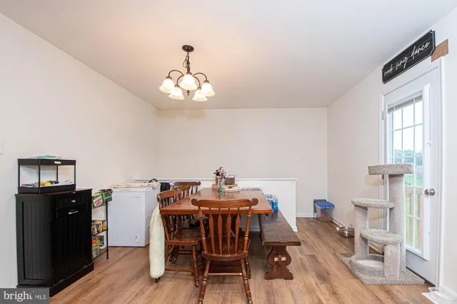 a view of a dining room with furniture wooden floor and a chandelier