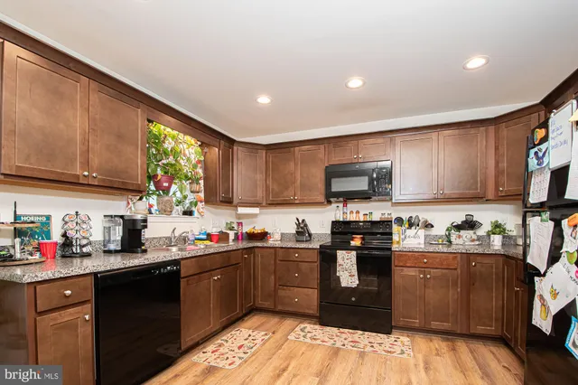a kitchen with stainless steel appliances granite countertop a stove sink microwave and cabinets