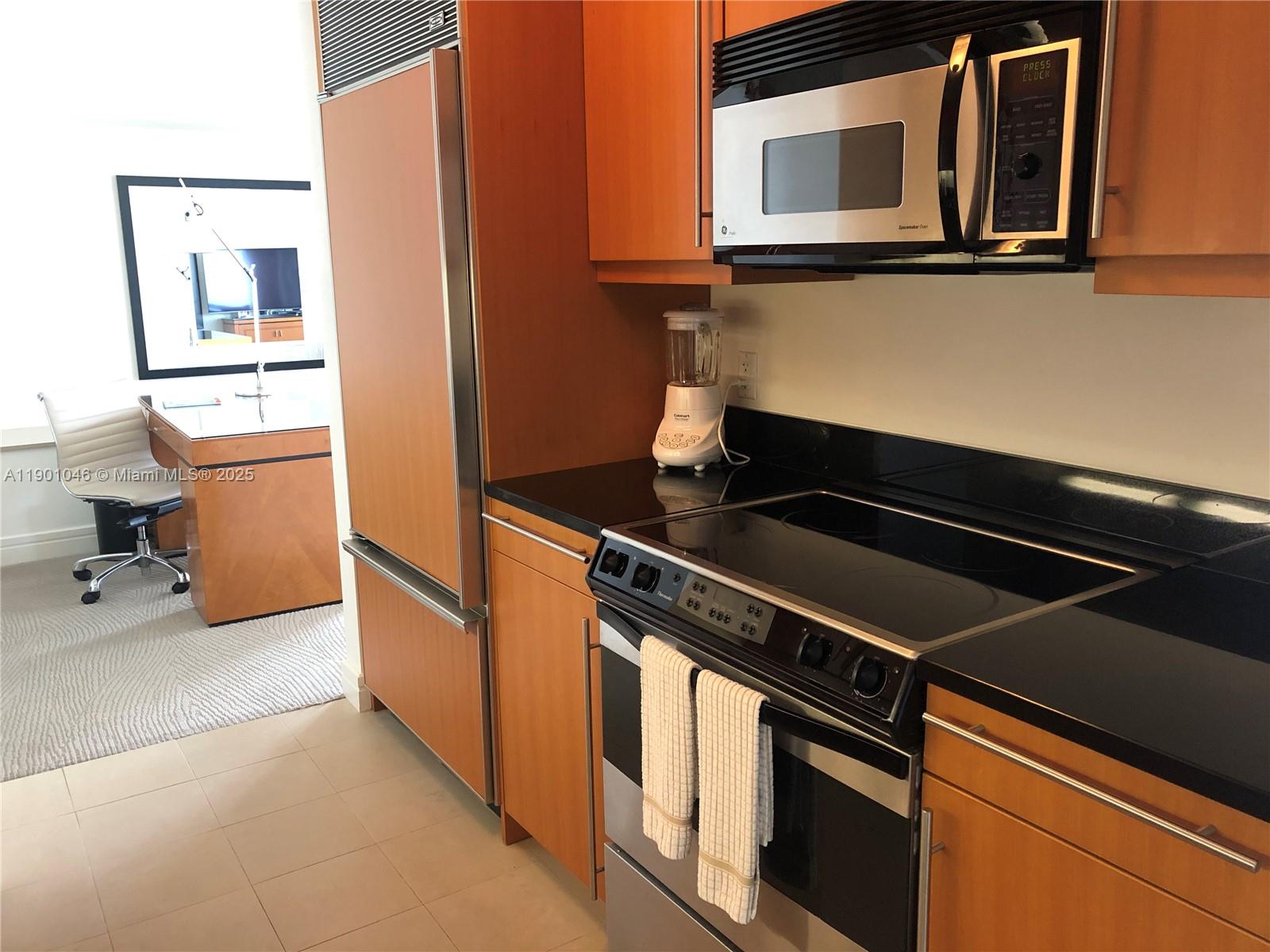 1435 Brickell Avenue, Unit 3506 Miami, FL 33131 - Photo 11 of 32 a kitchen with stainless steel appliances and cabinets