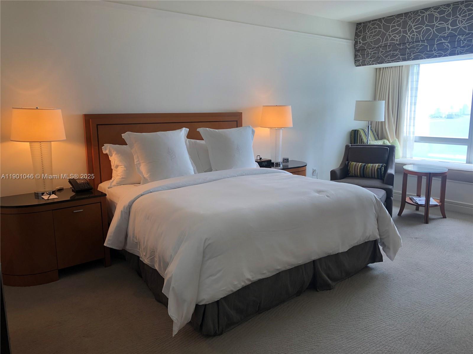 1435 Brickell Avenue, Unit 3506 Miami, FL 33131 - Photo 13 of 32 a bed sitting in a bedroom next to a window