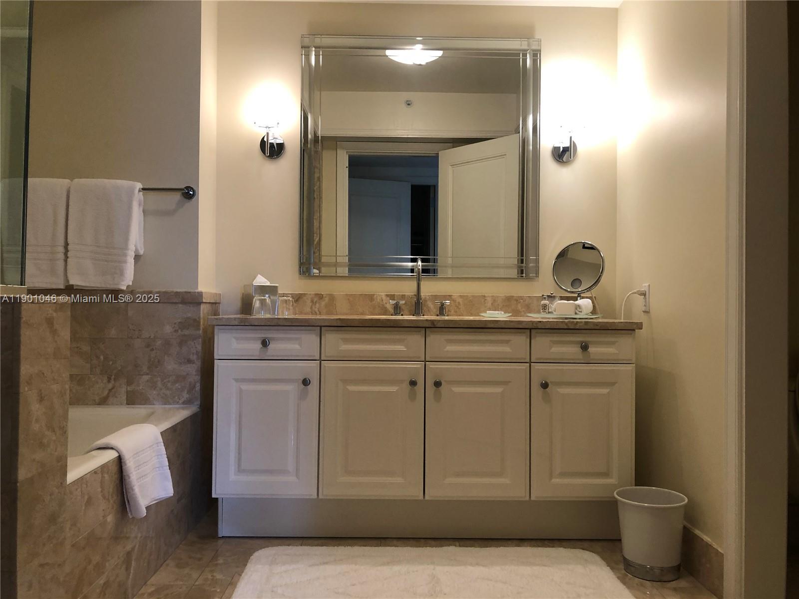 1435 Brickell Avenue, Unit 3506 Miami, FL 33131 - Photo 18 of 32 a bathroom with a sink and a mirror