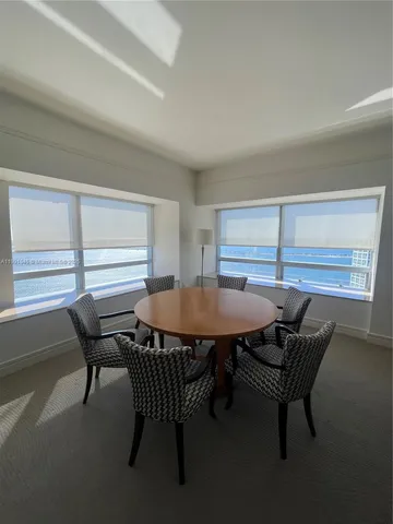 a view of a dining room with furniture and window