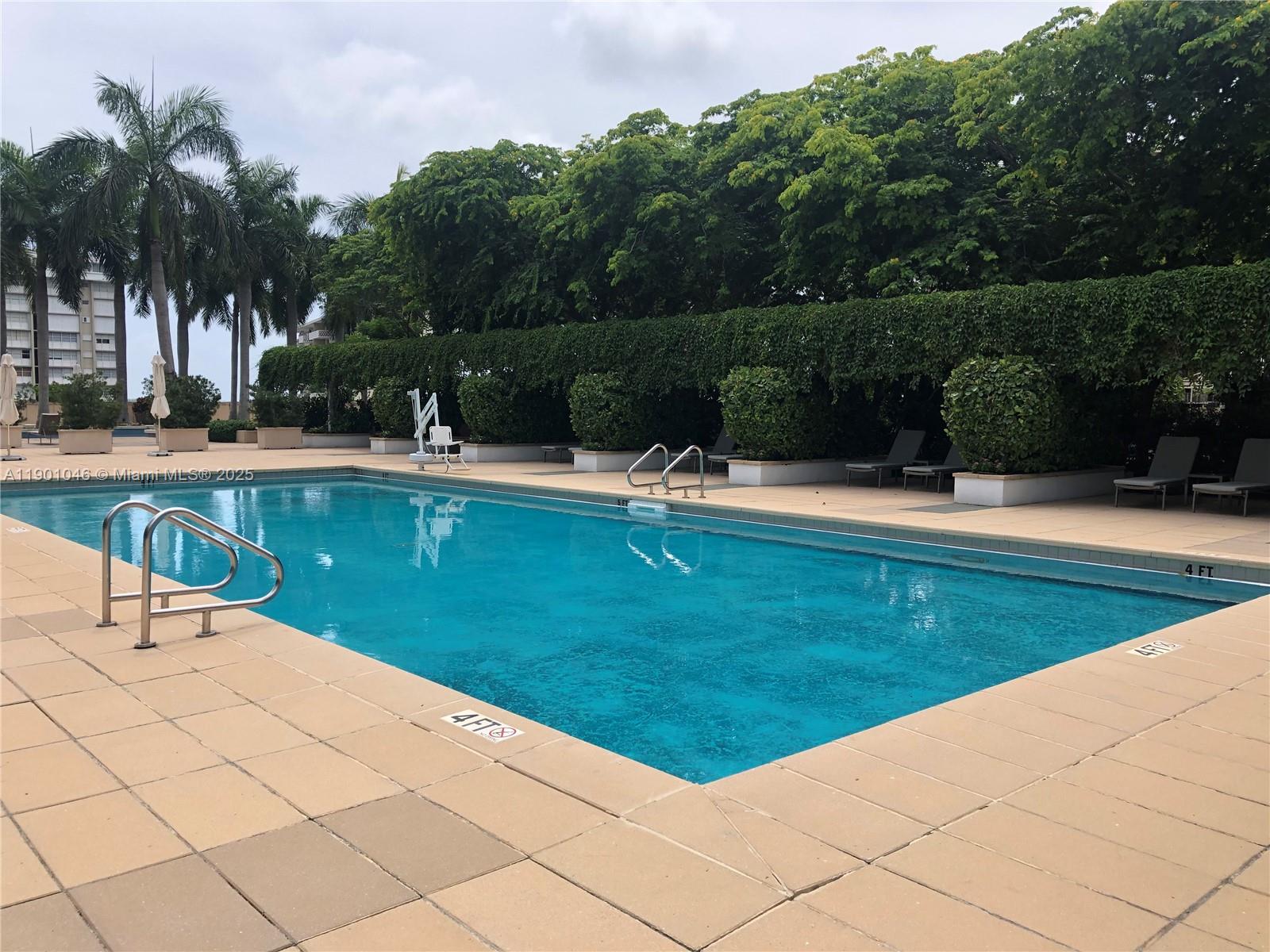 1435 Brickell Avenue, Unit 3506 Miami, FL 33131 - Photo 25 of 32 a swimming pool with outdoor seating and yard