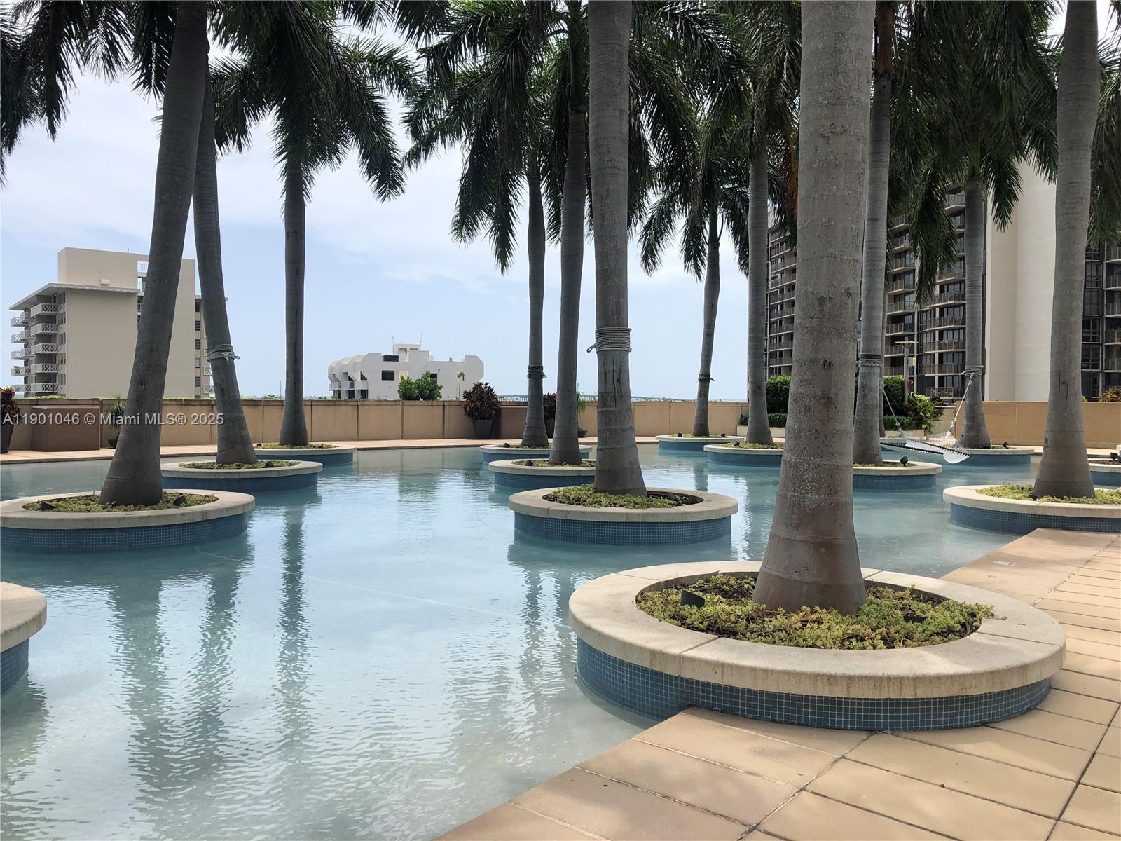 1435 Brickell Avenue, Unit 3506 Miami, FL 33131 - Photo 28 of 32 a view of a lake with a fountain and potted plants