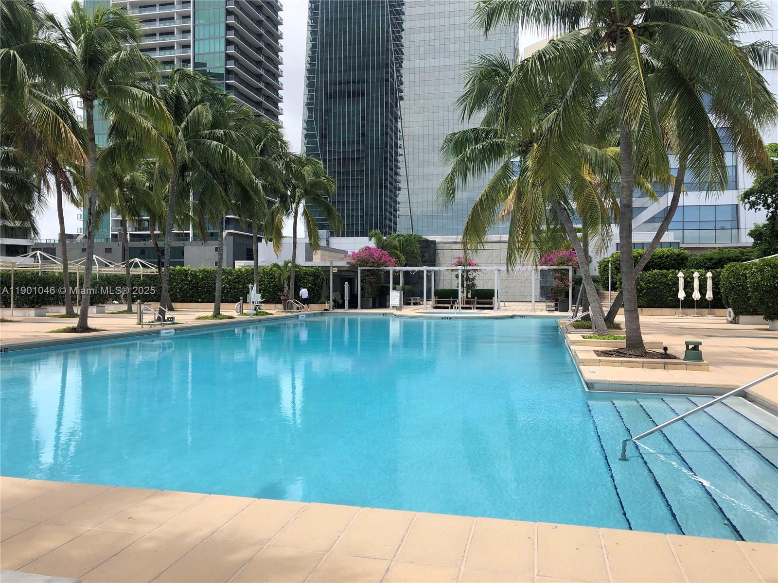 1435 Brickell Avenue, Unit 3506 Miami, FL 33131 - Photo 30 of 32 a swimming pool with outdoor seating and yard