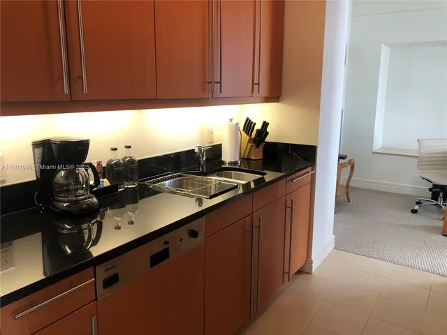 a kitchen with stainless steel appliances and cabinets