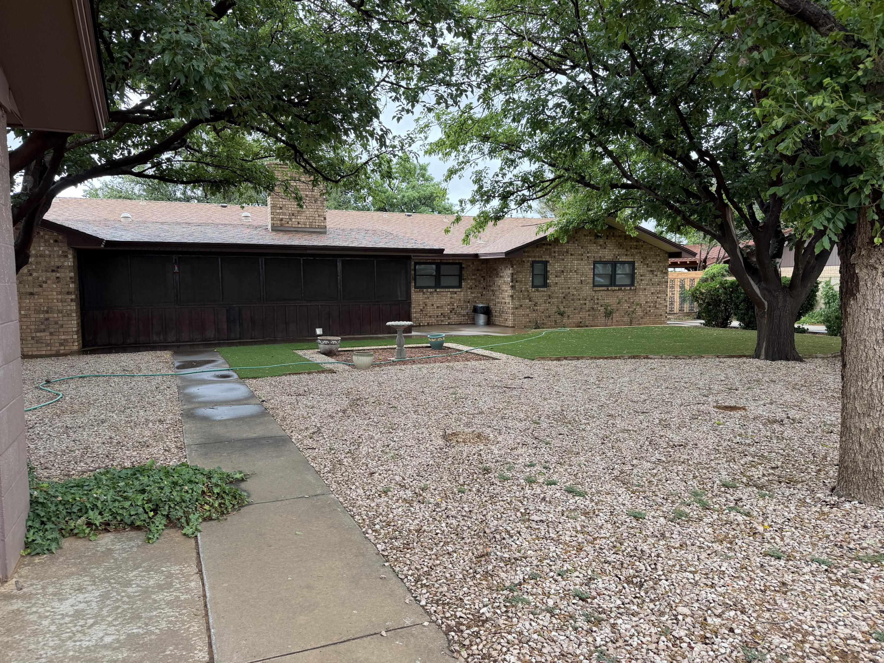 1603 South 8th Street Lamesa, TX 79331 - Photo 31 of 39 a front view of a house with a yard and garage