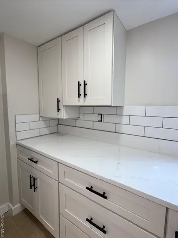 a kitchen with cabinets appliances a sink and a window