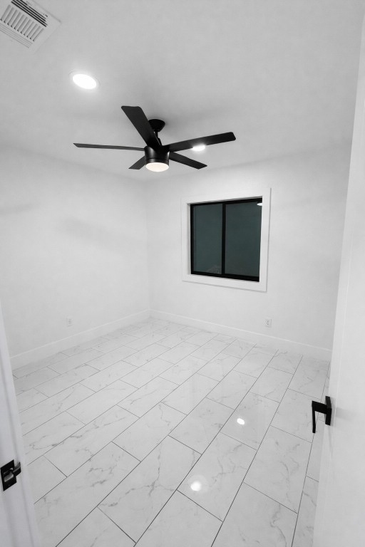 2014 Pecan Street Bastrop, TX 78602 - Photo 11 of 13 Empty room with ceiling fan, light marble finish floors, and recessed lighting