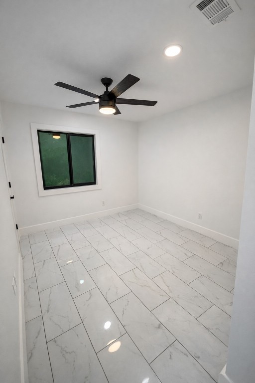 2014 Pecan Street Bastrop, TX 78602 - Photo 6 of 13 Spare room featuring a ceiling fan, light marble finish floors, and recessed lighting
