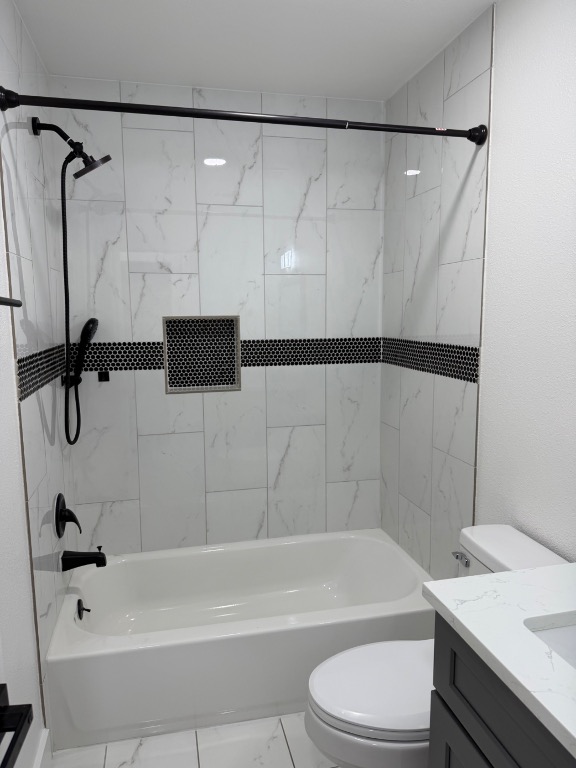 2014 Pecan Street Bastrop, TX 78602 - Photo 7 of 13 Bathroom featuring vanity, shower / bathtub combination, and marble finish flooring