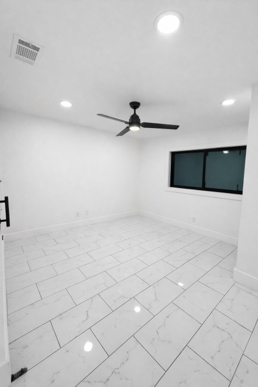 2014 Pecan Street Bastrop, TX 78602 - Photo 9 of 13 Empty room with light marble finish floors, recessed lighting, and a ceiling fan