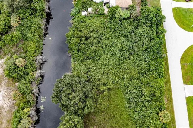 an aerial view of a house with a yard and garden